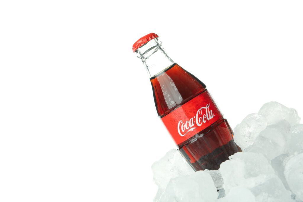 Odessa, Ukraine - 20 January, 2022. Coca-cola bottle in ice isolated on white background